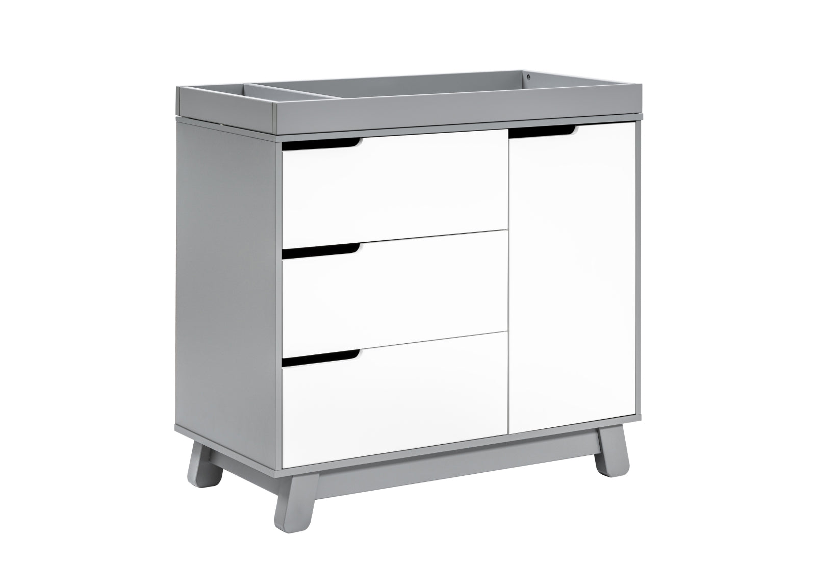 Modern white baby changing table with three drawers and a cabinet on short legs, isolated on a white background.