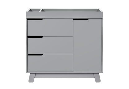 Modern gray baby changing table with three drawers and a cabinet, isolated on a white background.