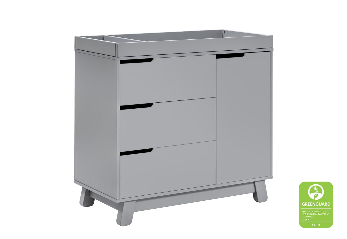 Modern gray changing table with three drawers and a door, featuring a GREENGUARD Gold certification badge for low chemical emissions.