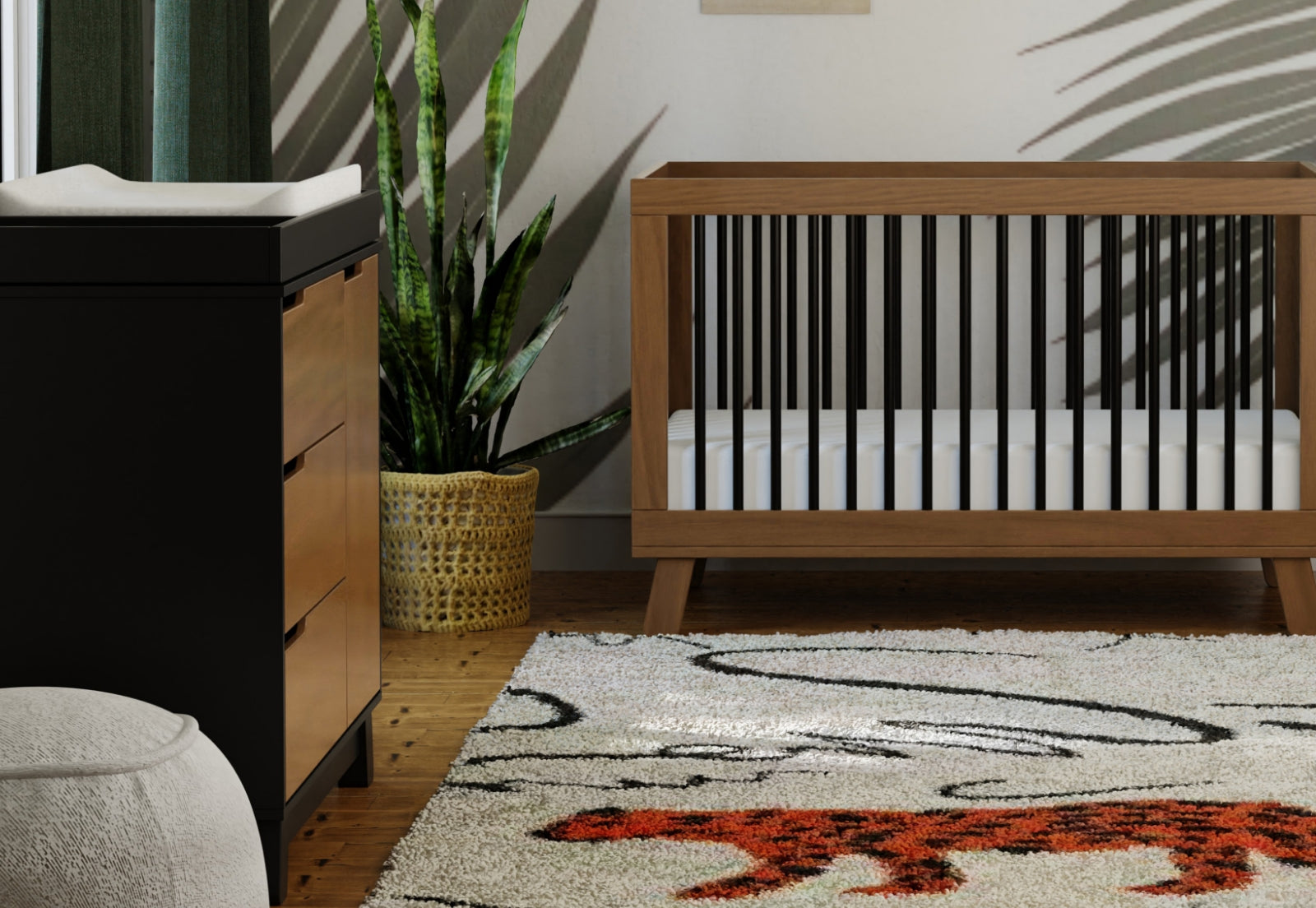 A stylish nursery featuring a modern crib and changing table, complemented by a decorative rug and indoor plants.