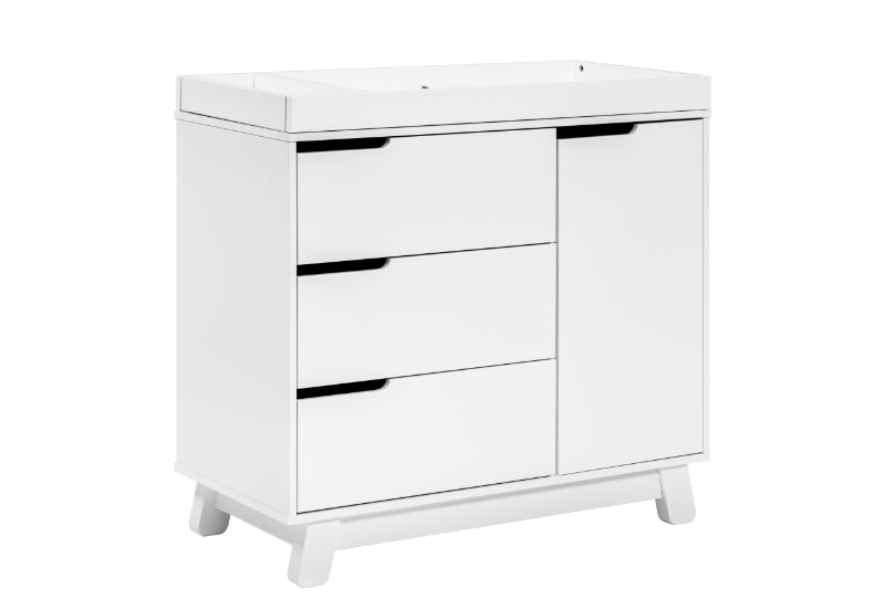 White baby changing table with three drawers and a cabinet on the side, set on a clean background.