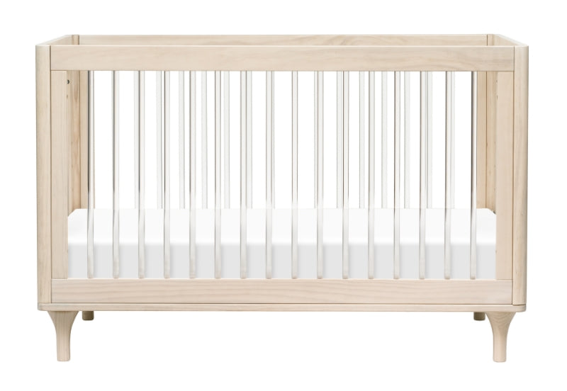 A modern light wood baby crib with white mattress and vertical bars, isolated on a white background.