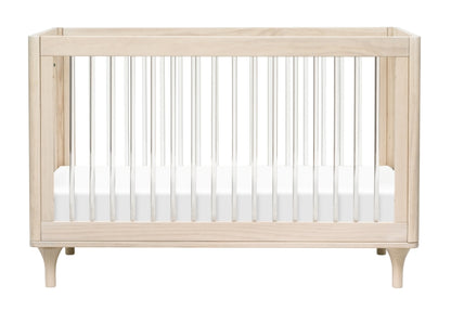 A modern light wood baby crib with white mattress and vertical bars, isolated on a white background.