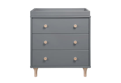 A modern grey nursery dresser with four drawers and wooden knobs on a white background.