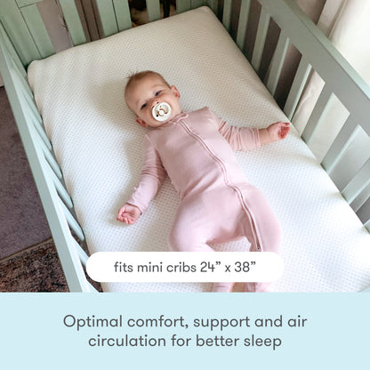 Baby in pink onesie resting on a breathable mattress in a crib, with text "Optimal comfort, support and air circulation for better sleep". 