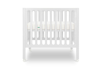 White modern crib on wheels with visible mattress, isolated on a plain background.