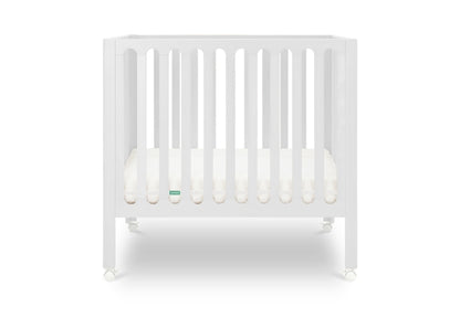 White modern crib on wheels with visible mattress, isolated on a plain background. Mattress in lowest position.