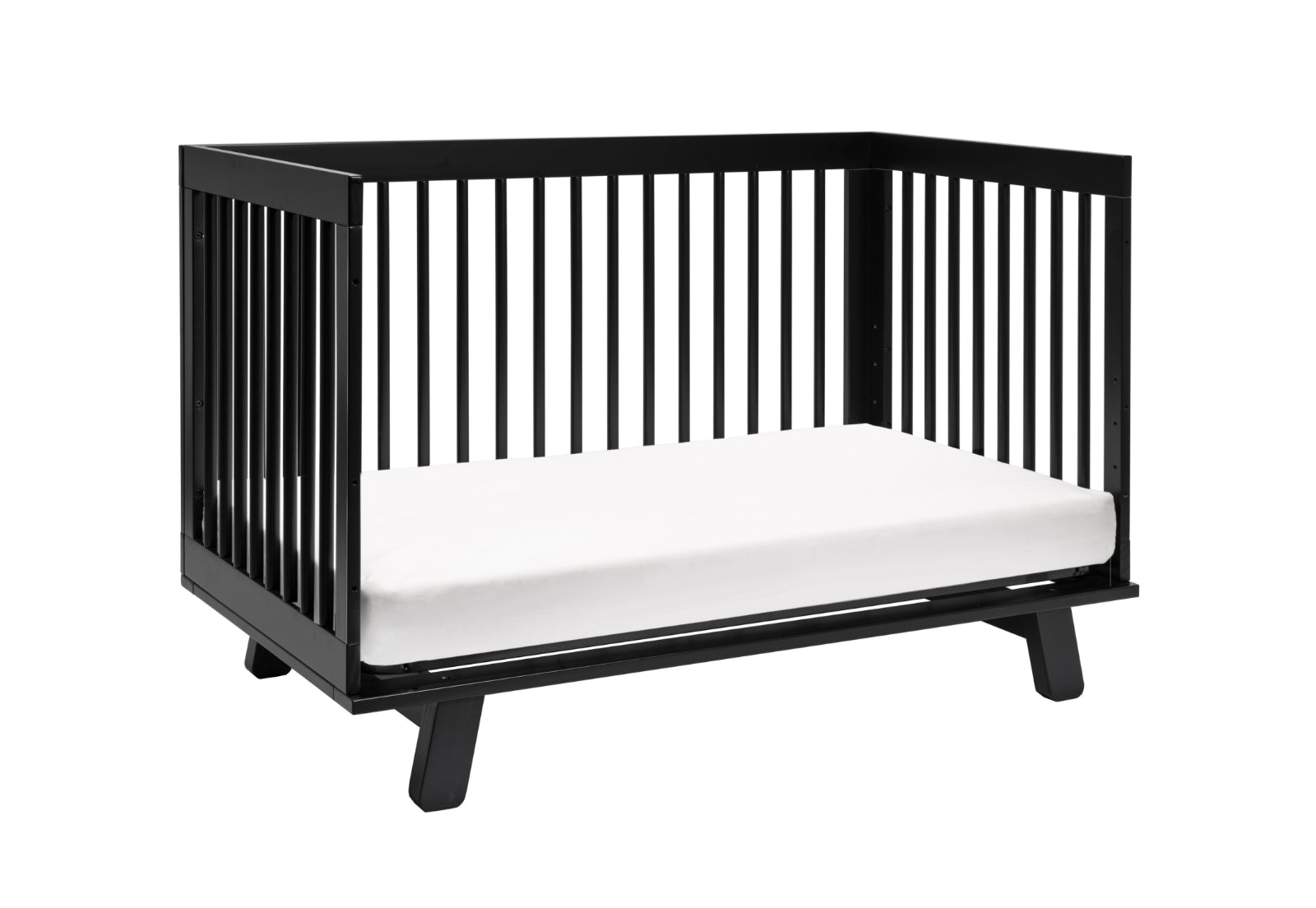 Modern black crib with a white mattress on a black base, isolated on a white background.