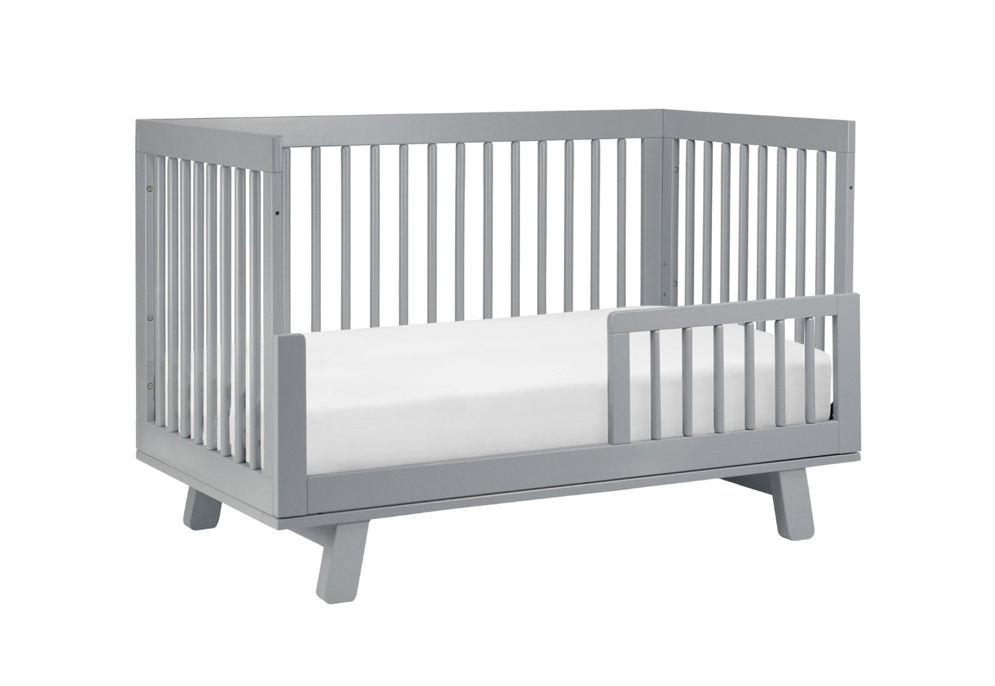 Modern gray baby crib with a visible mattress and slatted sides, isolated on a white background.