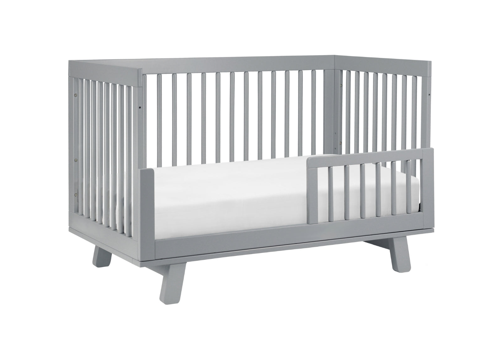 Modern gray baby crib with a visible mattress and slatted sides, isolated on a white background.