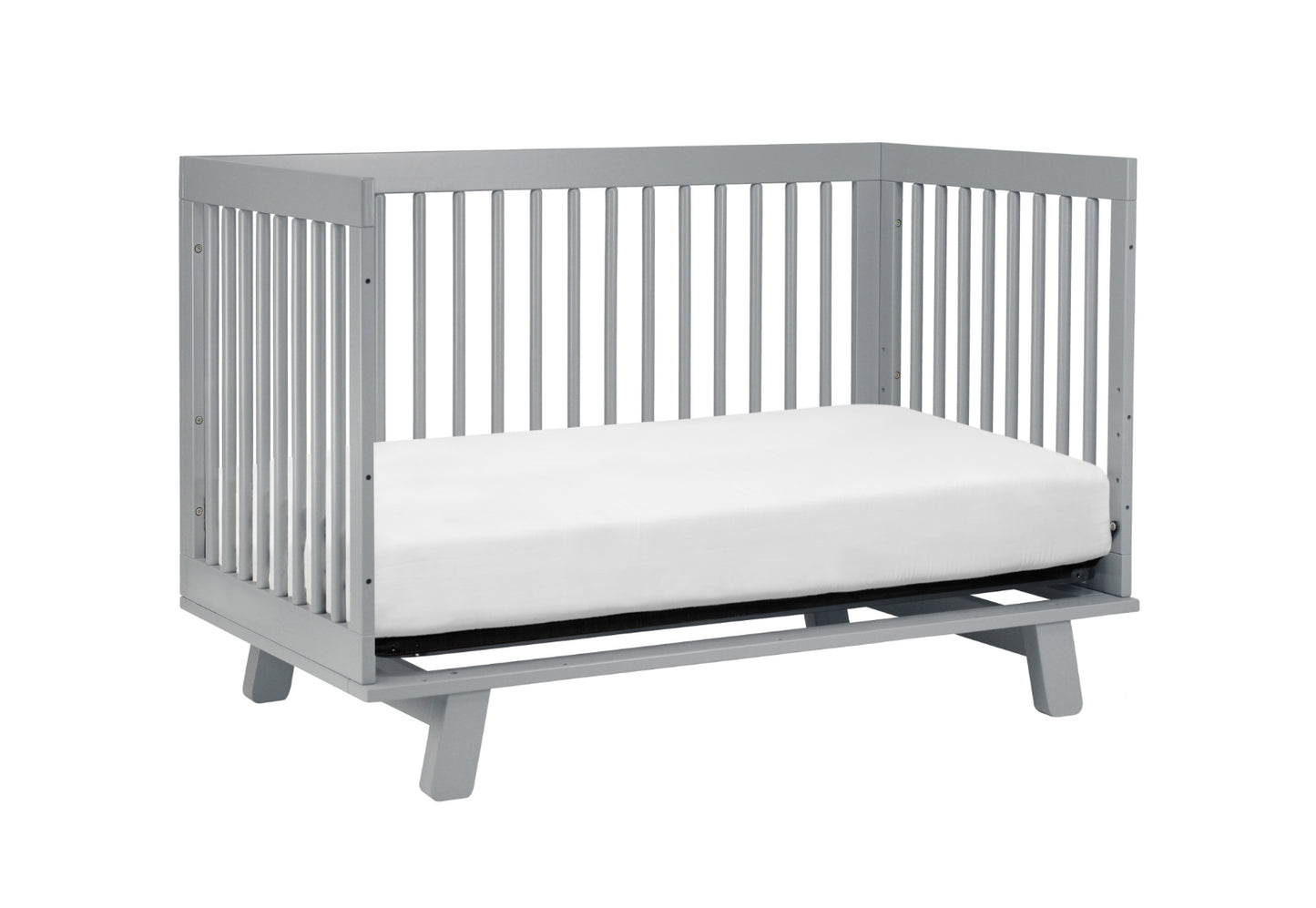 Gray modern baby crib with a white mattress on a plain background.
