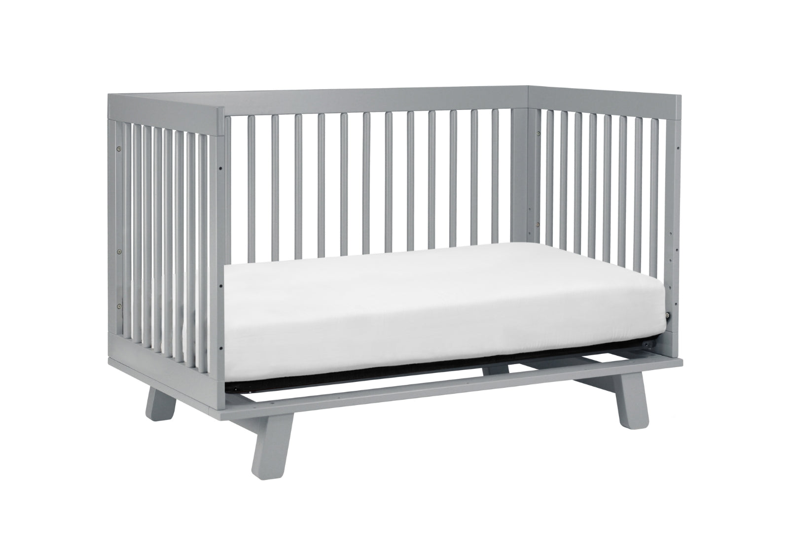 Gray modern baby crib with a white mattress on a plain background.