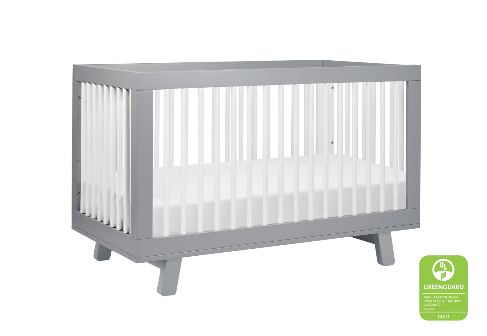 Modern gray baby crib with white mattress, certified low-emission by GREENGUARD Gold.