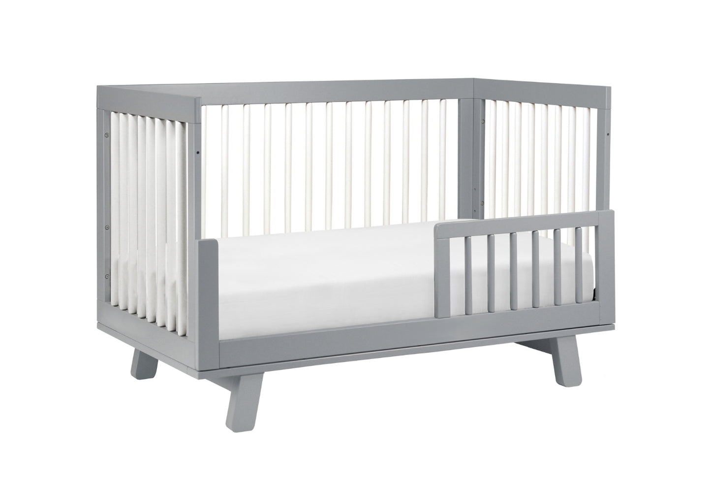 Gray modern baby crib with a white mattress, isolated on a white background.