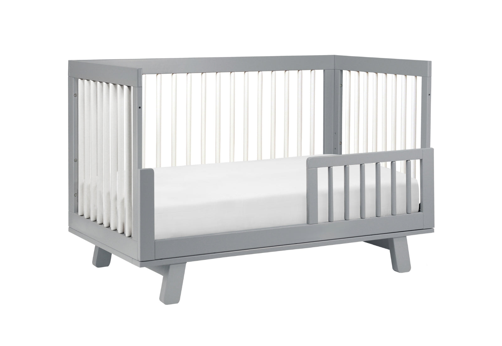 Gray modern baby crib with a white mattress, isolated on a white background.