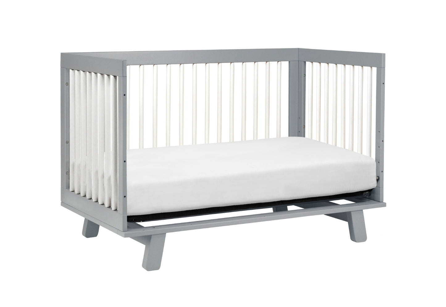 Gray modern baby crib with a white mattress, isolated on a white background.
