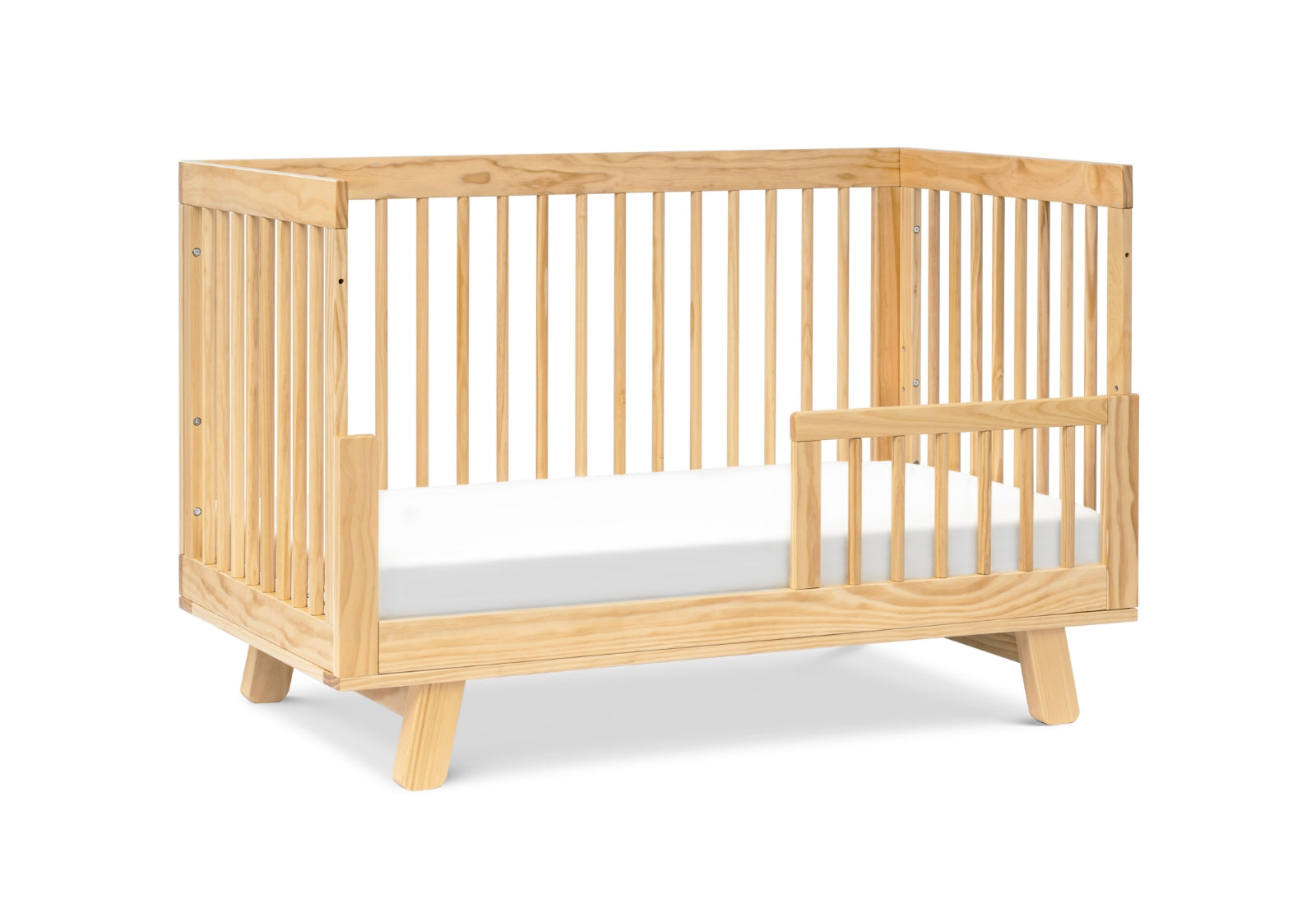 Modern wooden crib with a visible drop side on a white background.