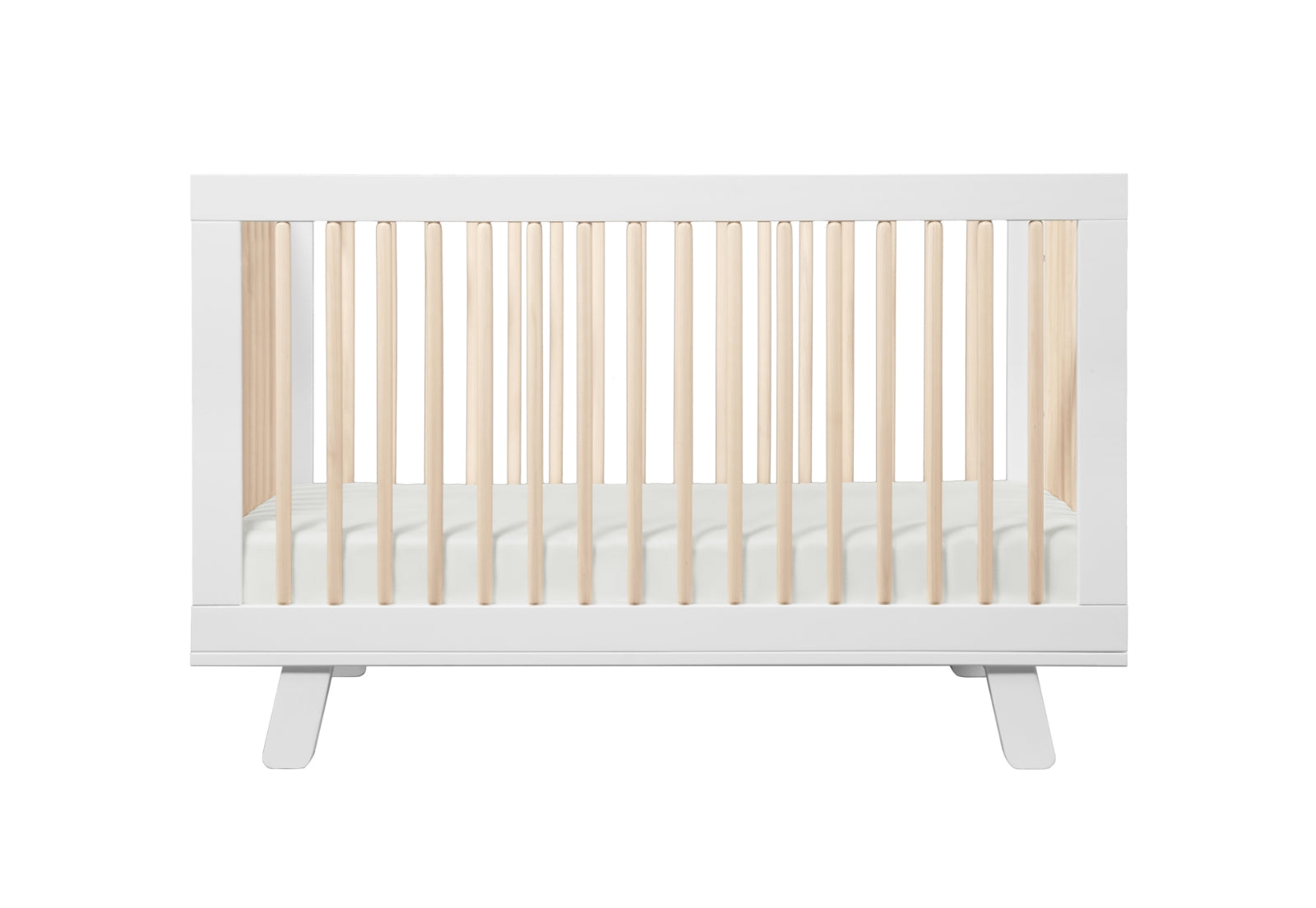 Modern white baby crib with a slated design and rounded corners, isolated on a white background.