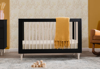 A stylish baby nursery featuring a modern black crib with a mustard yellow throw blanket, placed against a leaf-patterned wallpaper, with wooden toys on a plush carpet.