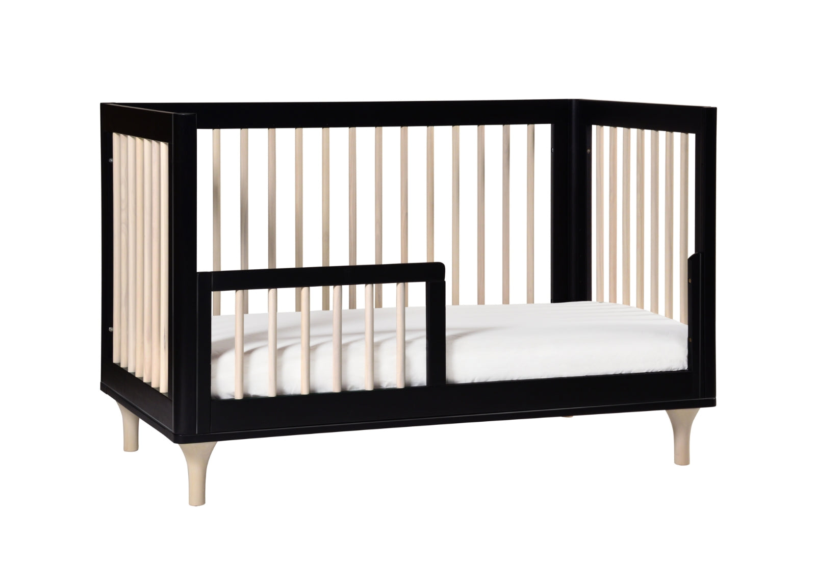 Modern black crib with slatted sides and a white mattress, displayed on a white background.