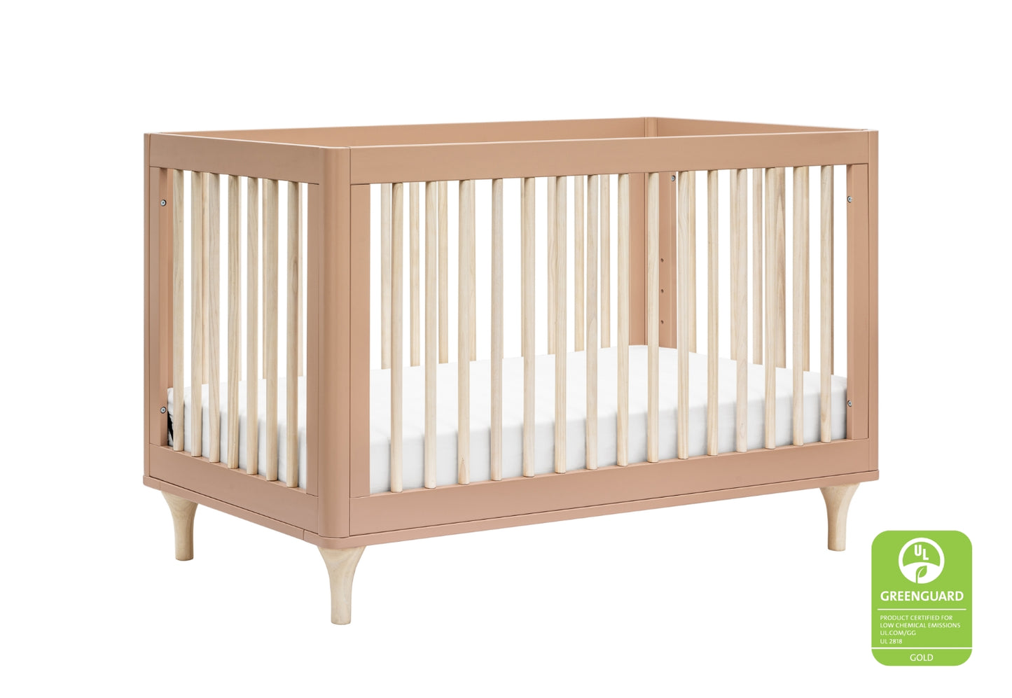 Modern baby crib with slatted sides and tapered legs in a light wood finish, featuring a white mattress and certified by UL GREENGUARD Gold for low chemical emissions.