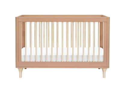 A modern blush pink crib with sturdy legs and slatted sides, shown without bedding.