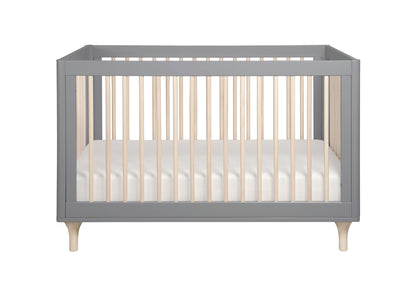 Modern gray baby crib with wooden legs and vertical slats, showcasing a white mattress.