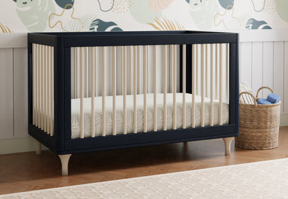 Navy blue crib with white bars, positioned in a nursery featuring a whale-themed wallpaper and a basket filled with soft toys.