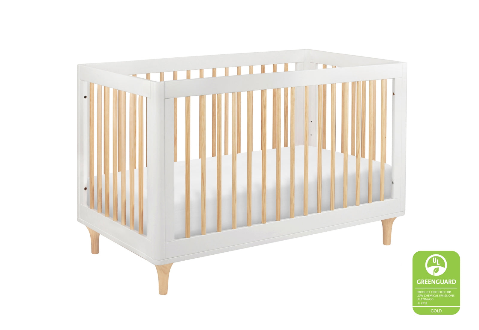 Modern white and natural wood crib certified by GREENGUARD as a low emission product, displayed on a white background.