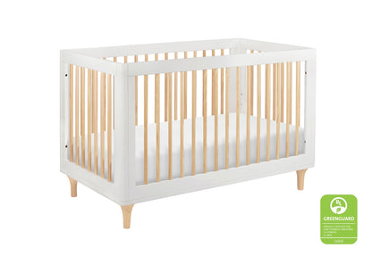 Modern white and natural wood crib certified by GREENGUARD as a low emission product, displayed on a white background.