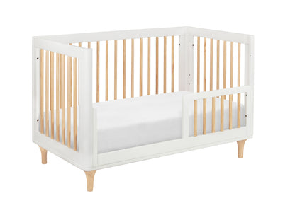 Modern white and natural wood baby crib with a simple, sleek design.
