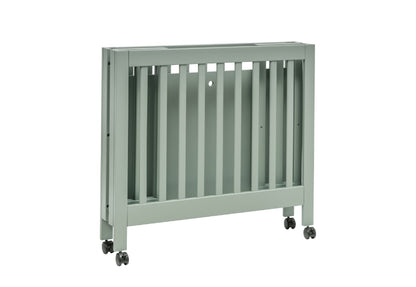 Gray baby crib on wheels with vertical slats, isolated on a white background.