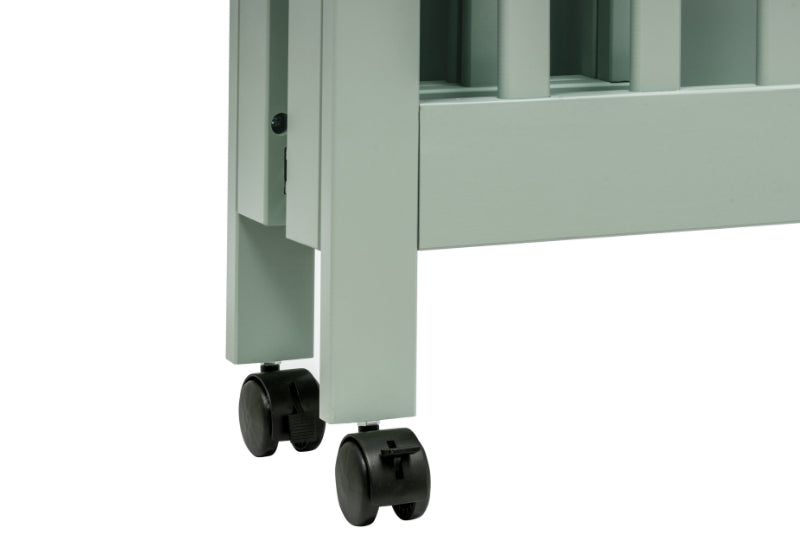 Close-up of a crib's gray leg and wheels on a plain background, showcasing mobility features.