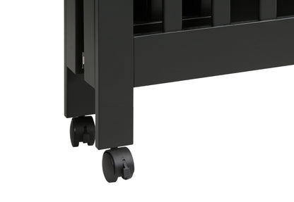 Close-up of a black crib's leg with lockable caster wheels for easy mobility.