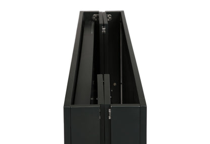 ALT Text: "Close-up view of a black, modern crib with visible hardware and sleek design, isolated on a white background."