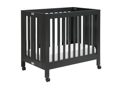 Stylish black crib on wheels with visible brand logo, showcasing a modern design and safety features.