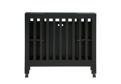 Black baby crib on wheels with a modern design, isolated on a white background.