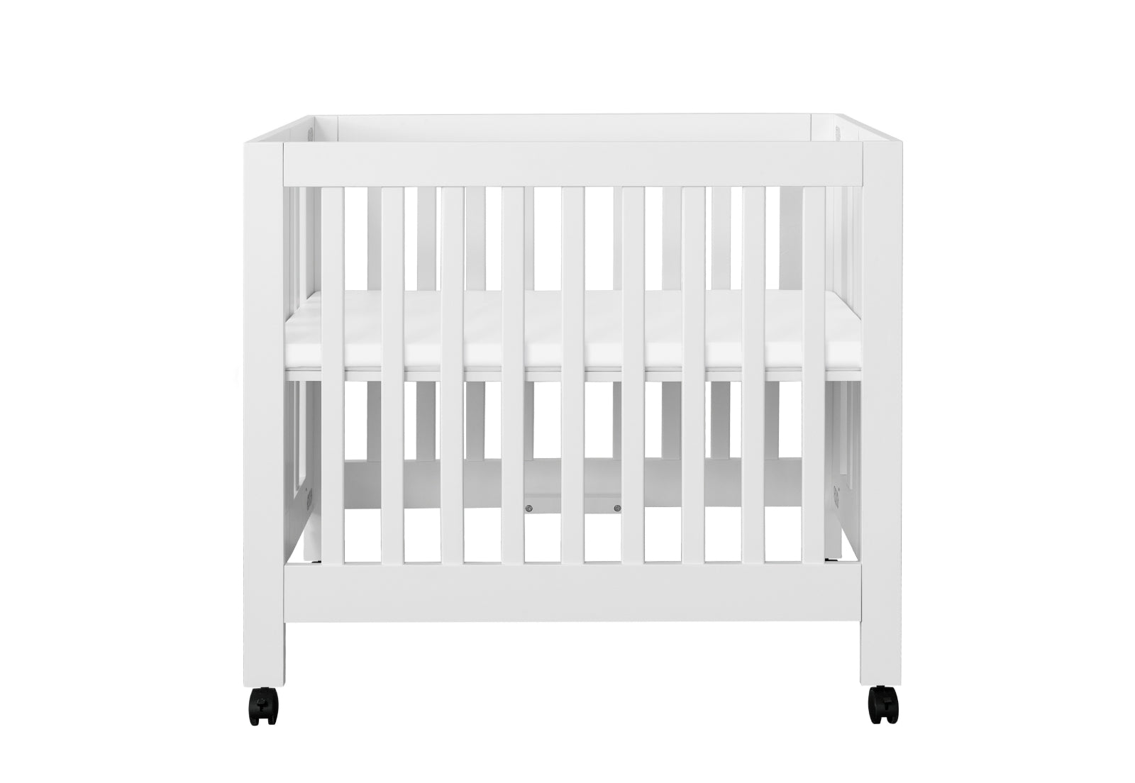 White baby crib on wheels with a visible mattress, isolated on a white background.