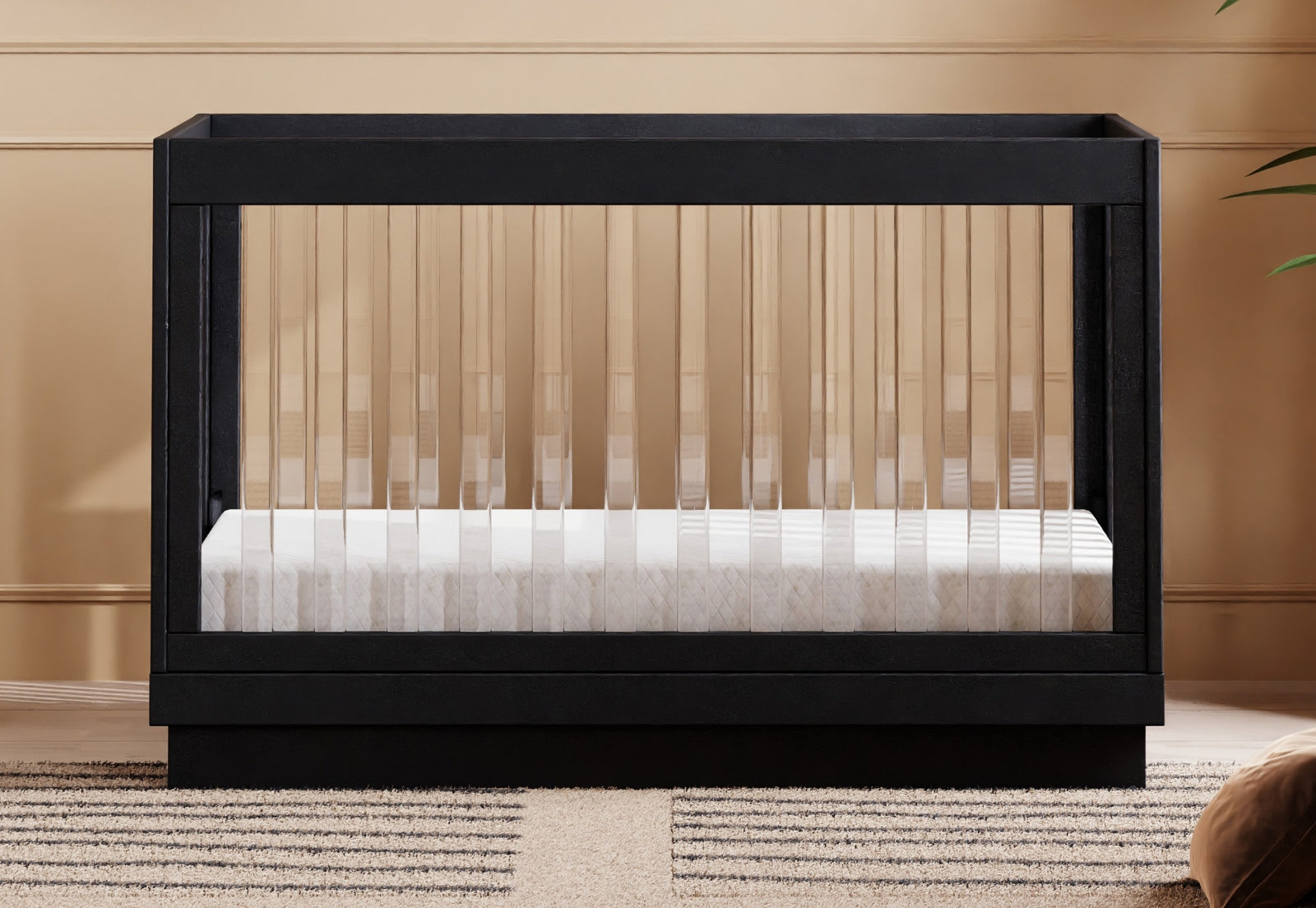 A modern black-framed baby crib with a mattress set in a warmly painted room. 999-8500-BLK