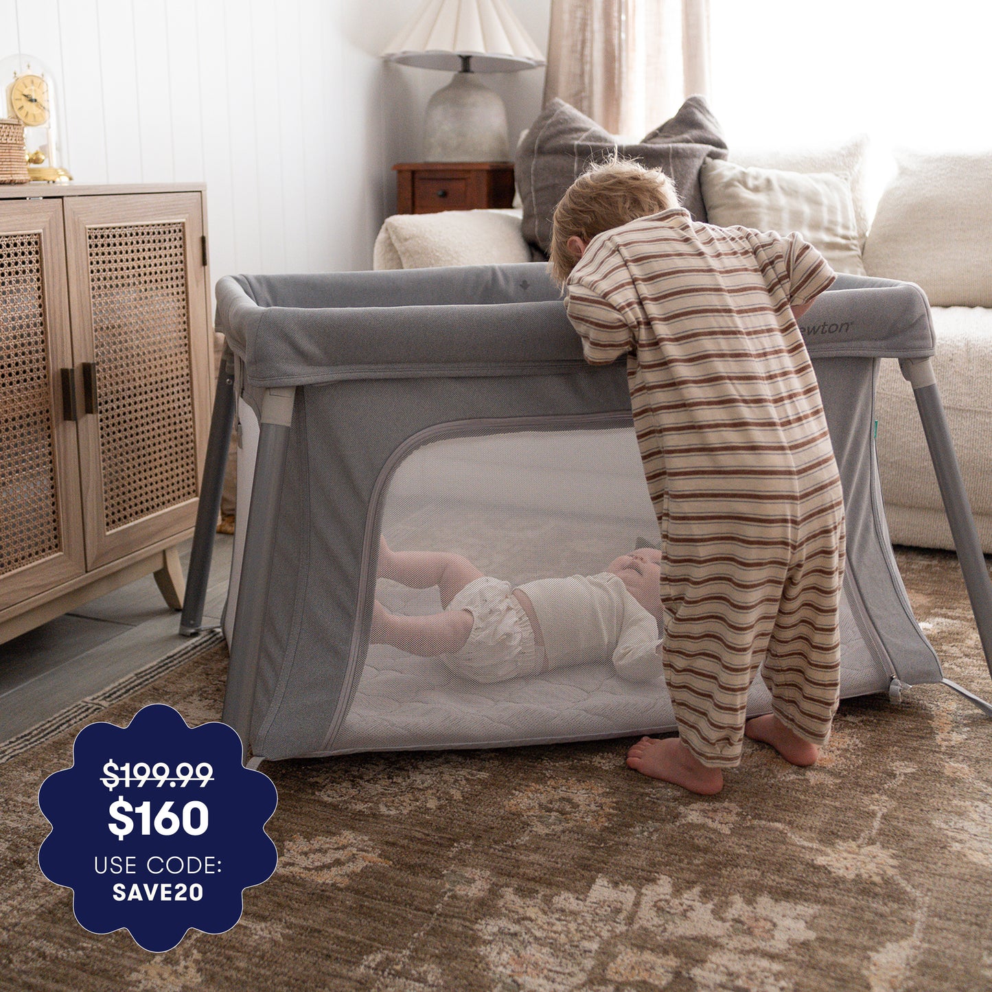 Child playing with a portable crib in a home setting 999-5101-GRY