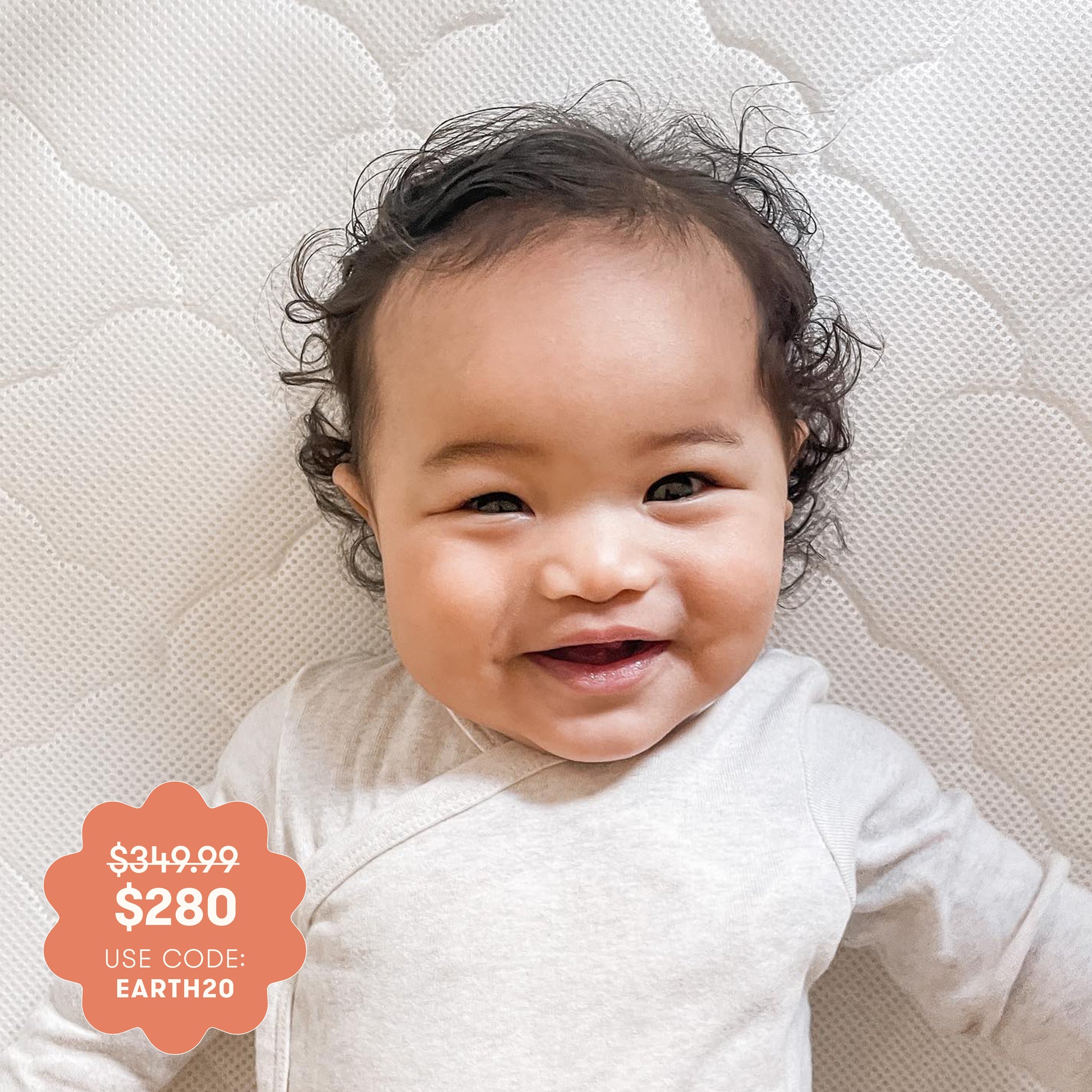 baby on mattress with promotional price burst.