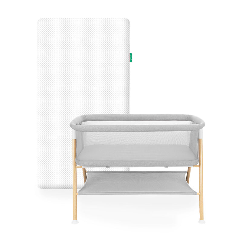 Newton essential bassinet and white newton essential mattress on white background