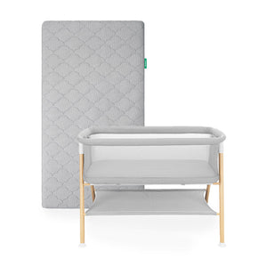 Newton essential bassinet and grey newton original mattress on white background