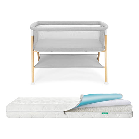 Newton waterproof mattress next to essential bassinet on a white background