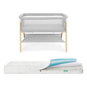 Newton waterproof mattress next to essential bassinet on a white background