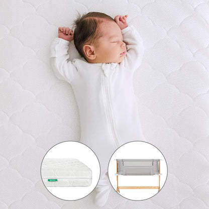 A baby in a white sleepsuit naps on the Newton Baby Bundle 3 BFCM: a quilted, washable crib mattress. Two circular insets below show close-ups of the mattress and a breathable bassinet with wooden legs.