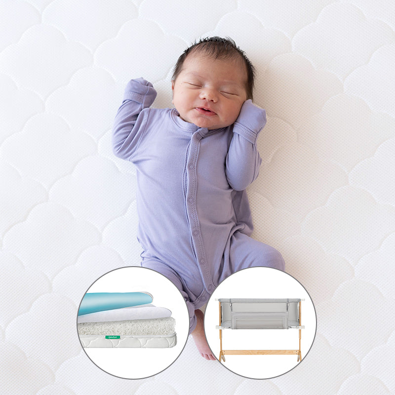 A newborn in a lavender onesie sleeps peacefully on a white surface. Insets highlight the Newton Baby Bundle 5 BFCM: a crib mattress cross-section and a gray bassinet with wooden legs.