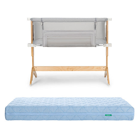 The Bundle 3 BFCM by Newton Baby features a wooden-framed, breathable bassinet with mesh sides, displayed above a light blue, quilted, washable crib mattress on a white background.