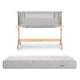 The Newton Baby Bundle 3 BFCM includes a wooden-framed bedside sleeper with light gray mesh sides and a matching rectangular, quilted, washable crib mattress, both displayed against a white background.
