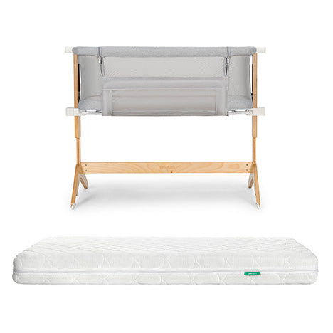 The Bundle 3 BFCM by Newton Baby includes a breathable bassinet with light grey mesh sides and a washable crib mattress with a subtle pattern and green tag, shown on a plain white background.